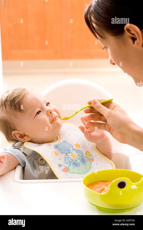 Mother Feeding Her Baby Stock Photo Alamy