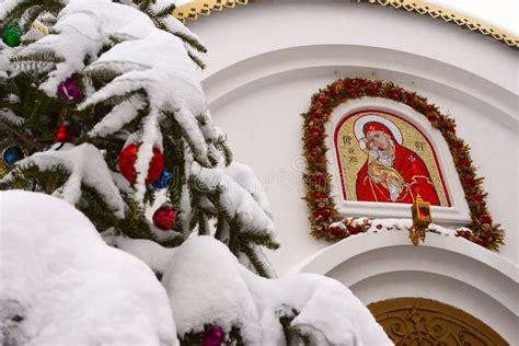 Snow Covered Christmas Tree Branch On The Background Of The Orthodox