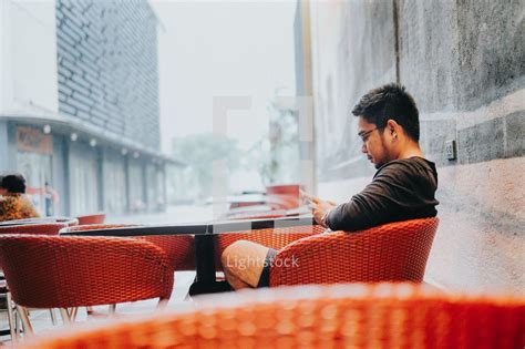 A Man Sitting Alone At A Table In A Restaurant — Photo — Lightstock