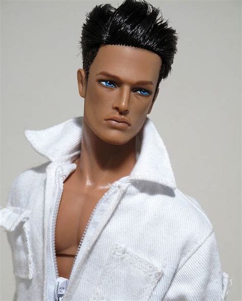 A Male Doll Wearing A White Shirt And Blue Eyes