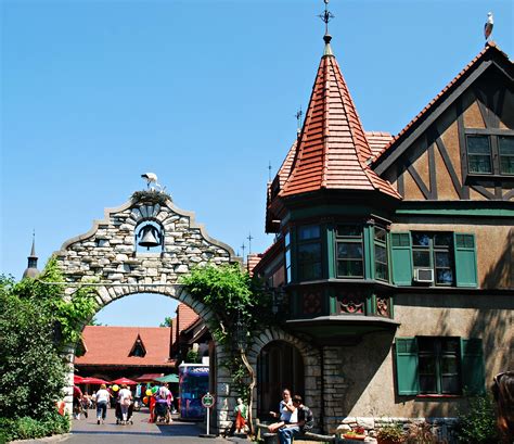 people are walking around in front of an old building