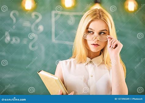 Attractive Lecturer Concept Woman With Book Starts Lesson Gazes At