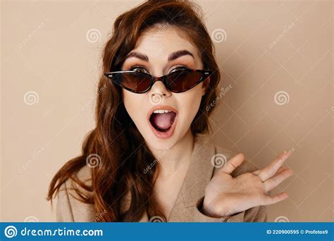 Woman In Glasses With Open Mouth And Gesturing With Hands Beige Background Stock Image Image