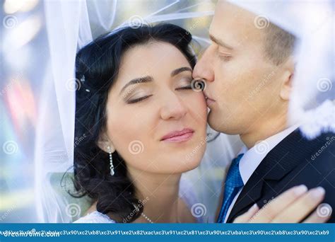 The Groom Gently Embraces And Kisses The Bride Stock Photo Image Of