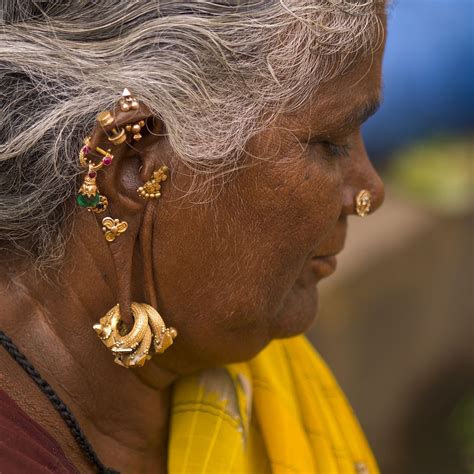 Hindu Woman With Several Earrings And Rings Hung At Her Ears Madurai