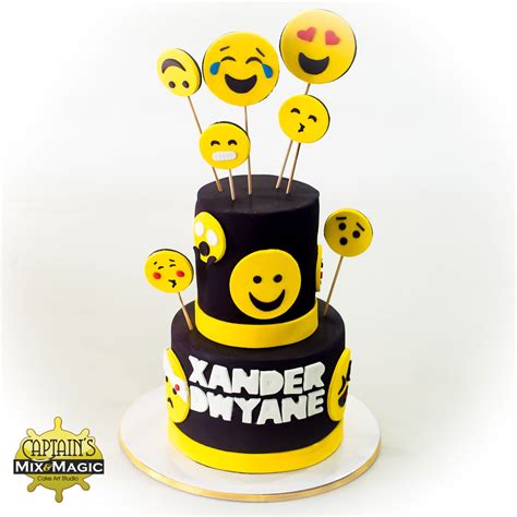 A Black And Yellow Cake With Smiley Faces On It