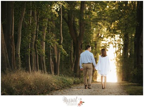 Timeless Outdoor Engagement Portrait Of A Couple Walking Hand In Hand