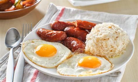 Filipino Silog Breakfast With Garlic Fried Rice Longsilog And Two Sunny Side Up Eggs Stock