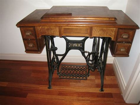 an antique sewing machine sits on a wooden table