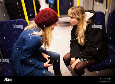 Two Teenage Girls Talking On Subway Train Stock Photo Royalty Free