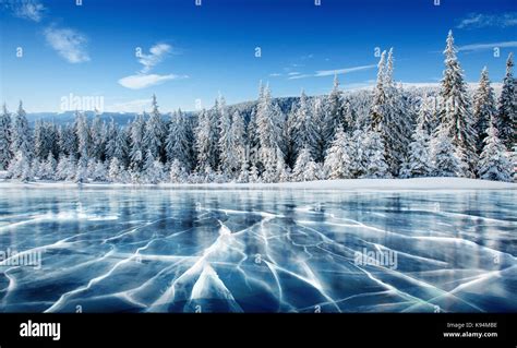 Blue Ice And Cracks On The Surface Of The Ice Frozen Lake Under A