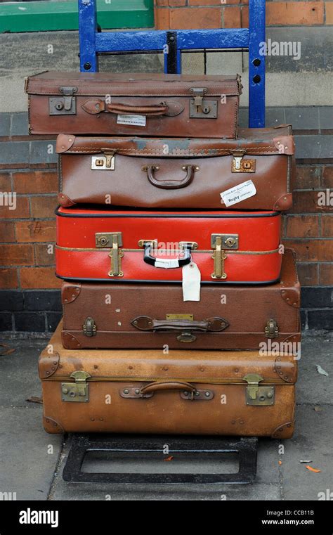 Old Luggage Suitcases Stacked On A Wheeled Trolley England Uk Stock