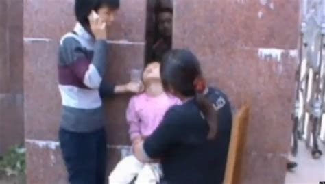 chinese girl gets head stuck in wall has to be chiselled out video huffpost uk