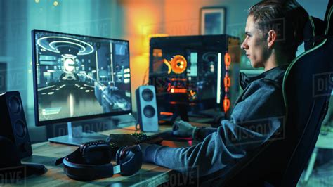 Cheerful Gamer Playing First Person Shooter Online Video Game On His Powerful Personal Computer