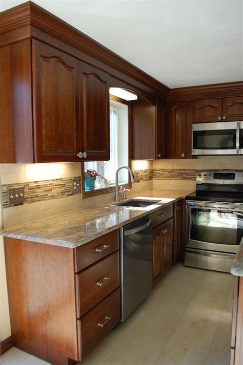 A kitchen dominated by dark tones is designed with marble countertop, black backsplash tile and dark cherry wood cabinets. Traditional Cherry wood Kitchen remodel w/ Hazelnut stain finish - Traditional - Kitchen ...