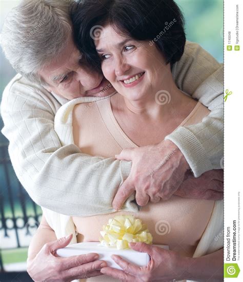 These gifts may not be nostalgic, but they'll help anyone elderly in your life manage their day effectively. Elderly Happy Couple With Gift Box Stock Photo - Image of ...