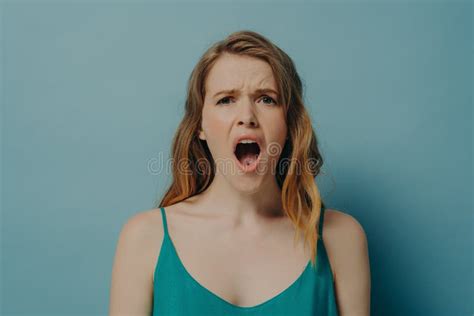 Shocked Female Posing On Camera With Mouth Wide Open And Disappointed