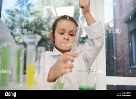 Smart Primary School Student Using Pipette Drips Reagent Into A Test