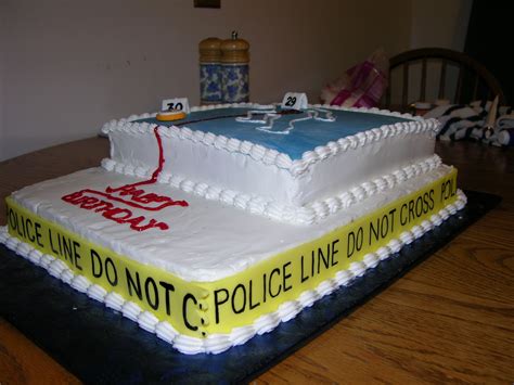 a cake that is sitting on top of a table with a police car on it