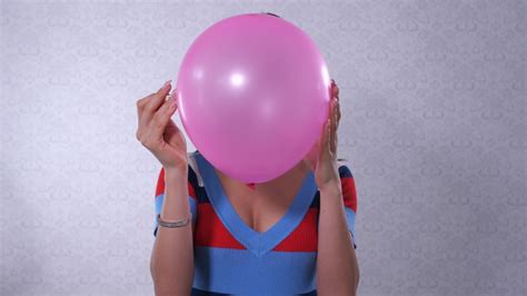 Girl Inflating A Pink Balloon Royalty Free Video