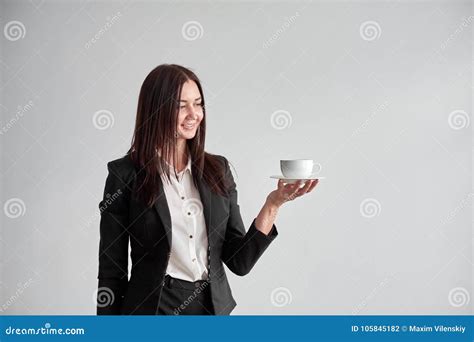 Office Worker Offering You A Cup Of Coffee Or Tea Over White Background