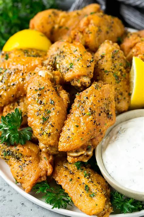 Lemon Pepper Wings Topped With Parsley And Served With A Side Of Ranch