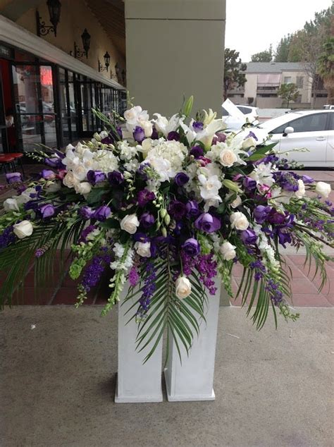 As with men, red, white and other more gender neutral colors are also an option for casket sprays for women. White and Purple Casket Spray by Robinson's Flowers