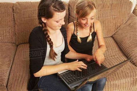 Two Girls Using Laptop Stock Photo Dissolve