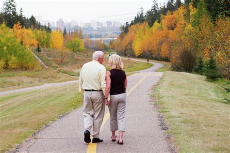 Mature Married Couple Walking Together In Park During Fall Season Edmonton Alberta Canada