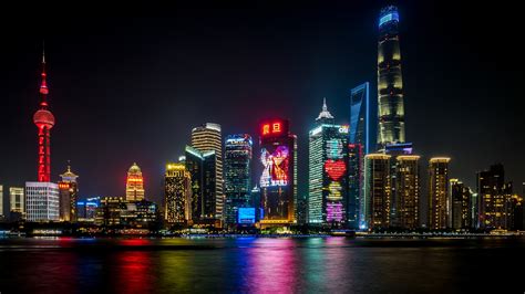 Shanghai Skyline Night Lights Reflecting In The Water By Marci Marc