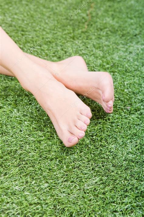 Beautiful Slim Female Feet On Grass — Stock Photo © Svyatoslavlipik