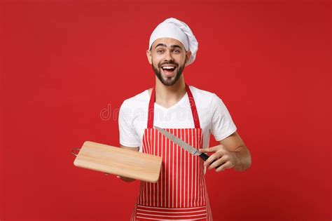 Excited Young Bearded Male Chef Cook Or Baker Man In Striped Apron White T Shirt Toque Chefs Hat