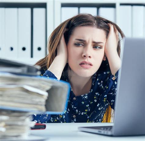 Tired And Exhausted Woman Looks At The Mountain Of Documents Propping