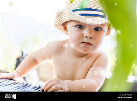 Portrait Of Curious Baby Boy Wearing Straw Hat Stock Photo Alamy