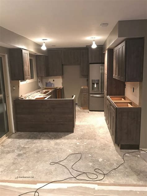 I'm gutting the kitchen… should the floor go in first or should i have the cabinets install first and have the floor meet up with the edge of the cabinets? Sharing the Before and After with Pergo Laminate Flooring