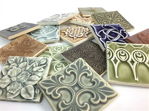 An Assortment Of Handmade Decorative Tiles In A Variety Of Glazes By