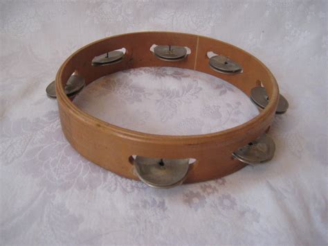 The tambourine is a musical instrument in the percussion family consisting of a frame, often of wood or plastic, with pairs of small metal jingles, called zills. Vintage tamborine wood tamborine vintage musical ...