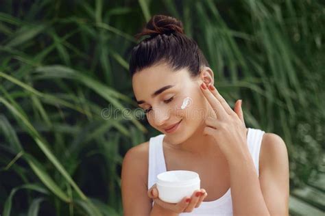 Beauty Concept Woman Applying Cosmetics Cream Spreads It On Her Face