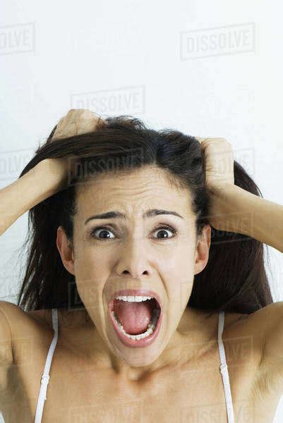 Woman Pulling Hair And Screaming At Camera Portrait Stock Photo