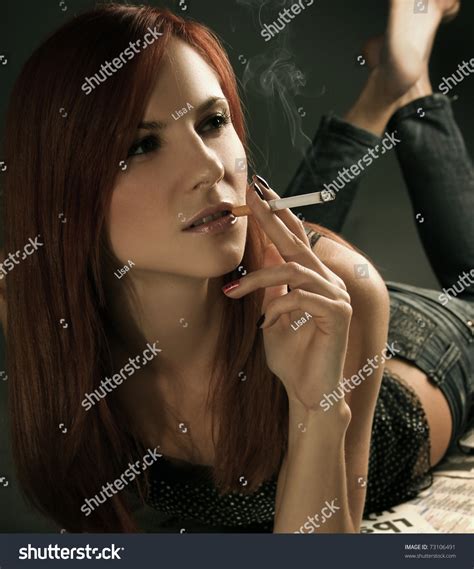 Beautiful Young Woman Smoking Cigarette Stock Photo