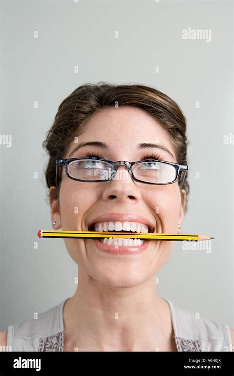 Woman With Pencil In Her Mouth Stock Photo Alamy