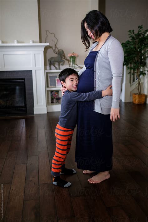 Pregnant Asian Woman With Her Son At Home By Stocksy Contributor