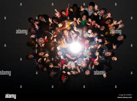 Diverse Crowd Cheering Around Bright Light Stock Photo Alamy