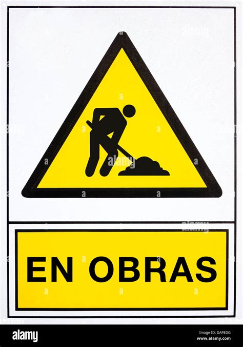 Under Construction Signal In Spanish Language Stock Photo Alamy