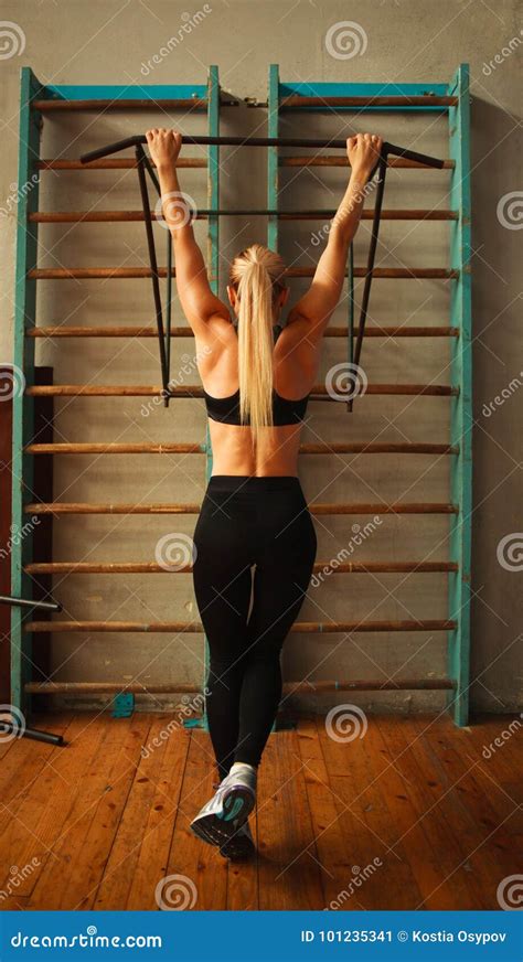 sporty athlete woman exercising doing pull ups in gym from back stock image image of back