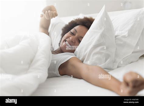 Beautiful Woman Waking Up In Her Bed She Is Smiling And Stretching