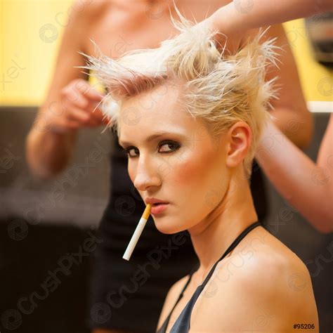 Sexy Woman Smoking Cigarette While Making Hair Style Stock Photo