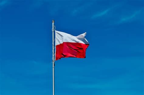 Premium Photo Polish Flag National Flag Of Poland On Blue Sky
