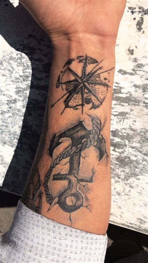 A Person S Arm With A Compass And Anchor Tattoo On The Left Side Of Their Wrist