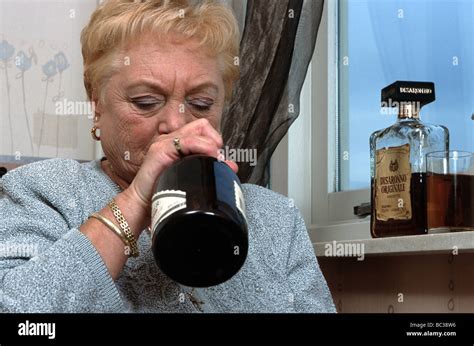 Drunk Old Woman Senior Woman Drinking From Bottle Stock Photo